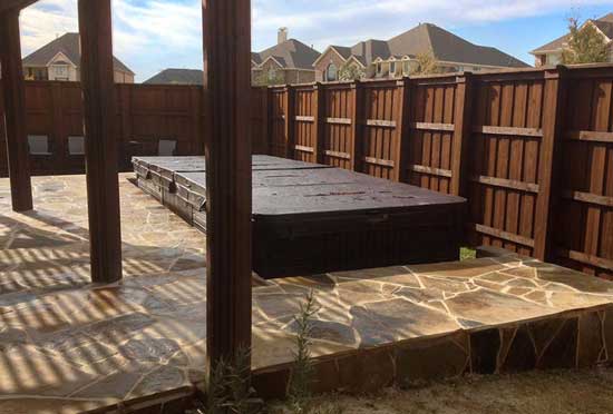 Stone patio featuring a covered swim spa