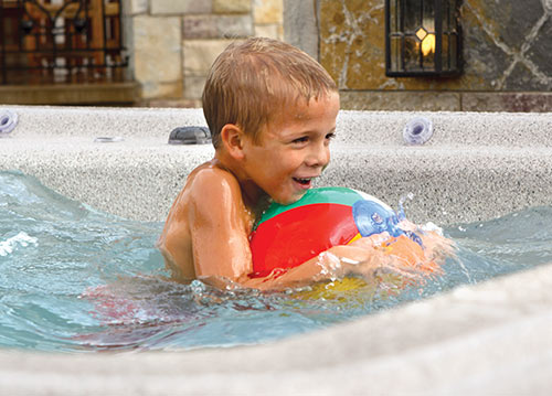 Boy playing with beach ball in the h2x swimspa