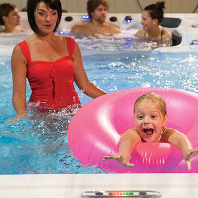 Girl floating in innertube towards edge of spa