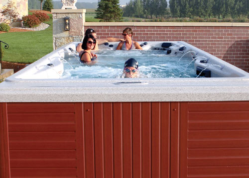 Couple relaxing watching a movie on their ipad in the h2x swimspa